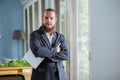 Portrait handsome businessman with beard holding tablet standing at side window office. happy smart man mature wear suit Royalty Free Stock Photo