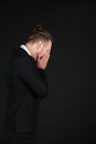 Portrait of handsome businessman in black suit feel stressed and disappointed emotion isolated on black background