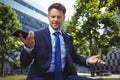 Portrait of handsome businessman holding mobile phone Royalty Free Stock Photo