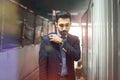 Portrait of handsome businessman holding necktie while standing in construction site tunnel. Royalty Free Stock Photo