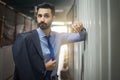 Portrait of handsome businessman leaning on metal construction. Royalty Free Stock Photo