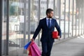 Portrait of an handsome businessman walking with shopping bag in a business center. Royalty Free Stock Photo