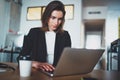 Portrait of handsome businesswoman using laptop computer at modern office.Blurred background.Horizontal.