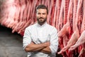 Portrait of a handsome butcher at the manufacturing