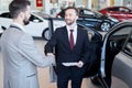 Car Salesman Shaking Hands with Client Royalty Free Stock Photo