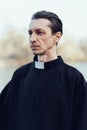 Portrait of handsome catholic priest or pastor with collar Royalty Free Stock Photo