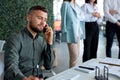 Portrait of handsome caucasian attractive man smiling talking at phone in office Royalty Free Stock Photo
