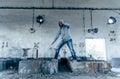 Portrait of a handsome caucasian hip hop dancer, freestyling outdoors in an old abandoned building, blue toned Royalty Free Stock Photo