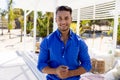 Portrait of handsome caucasian young man wearing blue shirt standing at tourist resort, copy space Royalty Free Stock Photo