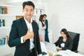 Portrait of a handsome CEO smiling, Portrait of a positive looking young business professional standing posing thumb up Royalty Free Stock Photo