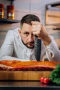 Portrait of handsome chef cooking raw meat in the kitchen. ÃÂ¡hef holds a professional kitchen knife. Concept of Cooking process Royalty Free Stock Photo