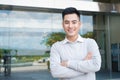 Portrait of an handsome confident asian man outside buidling. Royalty Free Stock Photo