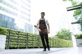 Portrait of a handsome and confident cafe owner standing waitress in brown apron walking in around his coffee shop.Small Business Royalty Free Stock Photo