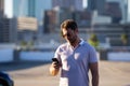 Portrait of handsome confident stylish man chatting on phone in big city. Sexy man in casual clothes talking on phone on Royalty Free Stock Photo