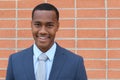 Portrait of handsome confident young African businessman smiling happy, looking at camera with copy space Royalty Free Stock Photo