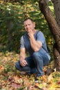 Portrait of a handsome courageous man with muscular arms, 60 years old, against the background Royalty Free Stock Photo