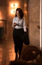 Handsome elegant caucasian businesswoman walking at modern restaurant and checking her smart phone