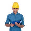 Portrait of handsome engineer student holding blue clipboard