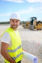 Portrait of handsome foreman construction worker on industrial building industry construction site