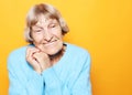 Portrait of handsome grandmother in blue sweater. Dreaming, wondering concept