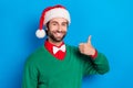 Portrait of handsome guy toothy smile hand finger demonstrate thumb up isolated on blue color background Royalty Free Stock Photo