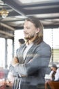 Portrait of happy businessman with arms crossed standing in office Royalty Free Stock Photo