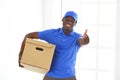 Portrait of an handsome happy deliverer with box