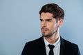 Portrait of handsome harsh man with bristle in black suit Royalty Free Stock Photo