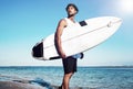 Model surfer wearing casual clothes going with surfboard on blue ocean Royalty Free Stock Photo