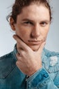 Portrait of a handsome long-haired man with drawn hair and freckles dressed in a denim shirt Royalty Free Stock Photo
