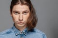 Portrait of a handsome long-haired man with freckles dressed in a denim shirt Royalty Free Stock Photo