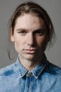 Portrait of a handsome long-haired man with freckles dressed in a denim shirt Royalty Free Stock Photo