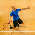 Portrait of a handsome male tennis player celebrating his success at court Royalty Free Stock Photo