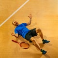 Portrait of a handsome male tennis player celebrating his success at court Royalty Free Stock Photo