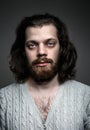 Portrait of a handsome man with a beard, long hair and big blue eyes Royalty Free Stock Photo