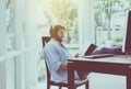 Portrait of handsome man with beard reading book and listening to music online at coworking space,Happy and smiling,Relax time Royalty Free Stock Photo