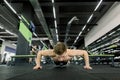 Portrait of a handsome man doing push ups exercise in fitness gym Royalty Free Stock Photo