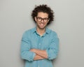 portrait of handsome man with glasses in blue denim shirt crossing arms Royalty Free Stock Photo