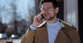 Portrait handsome man in glasses having phone talk on the street. Business man talking on smartphone at street. Outdoor Royalty Free Stock Photo