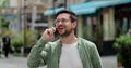 Portrait handsome man in glasses having phone talk on the street. Young business man talking on smartphone at street Royalty Free Stock Photo