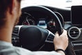 Portrait of handsome man going for a drive with brand new modern car, forest road winter details Royalty Free Stock Photo