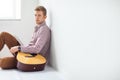 Portrait of handsome man with guitar siting on floor Royalty Free Stock Photo