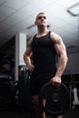 Portrait of a handsome man in gym. Coach, athlete, bodybuilder, muscular sexy body, darkness. serious Royalty Free Stock Photo