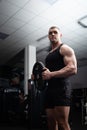 Portrait of a handsome man in gym. Coach, athlete, bodybuilder, muscular sexy body, darkness. stylish Royalty Free Stock Photo