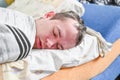 Portrait of handsome man having stubble, sleeping at home in bed. Young man on couch after fun. Royalty Free Stock Photo