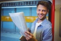 Portrait of handsome man holding newspaper while listening music Royalty Free Stock Photo