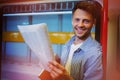 Portrait of handsome man holding newspaper while listening music Royalty Free Stock Photo