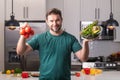 Portrait of handsome man in kitchen. Young man preparing delicious and healthy food in home kitchen. Man with recipe Royalty Free Stock Photo