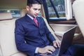 Handsome man looking his laptop inside car Royalty Free Stock Photo