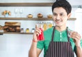 A portrait of handsome man making cold presses fruit juice in a modern kitchen.